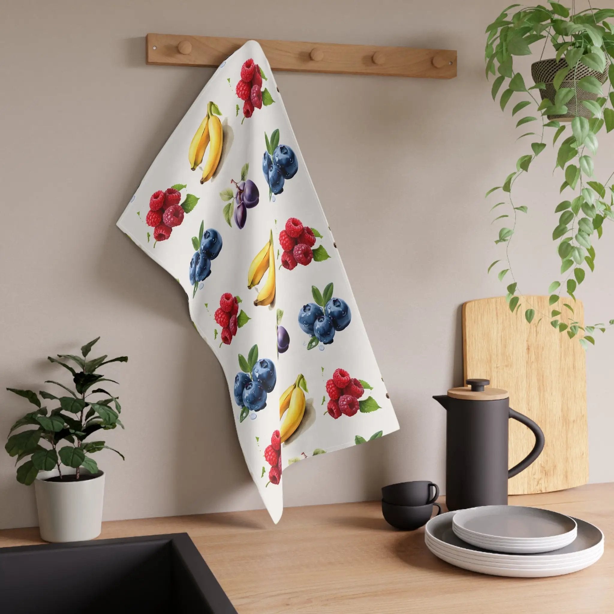 Kitchen Towel | a kitchen counter with a potted plant and a towel hanging on the wall