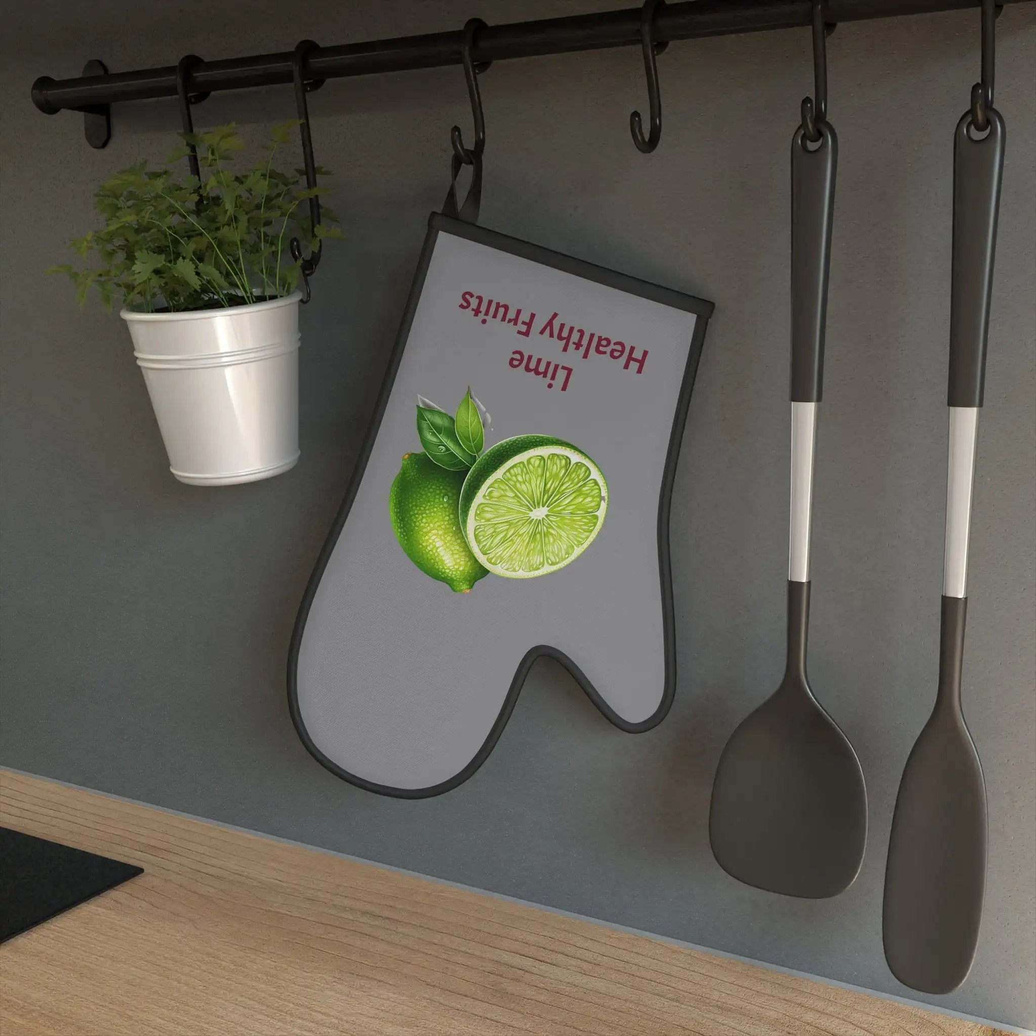 oven mitt | a kitchen wall with spoons, spatulas and a potted plant