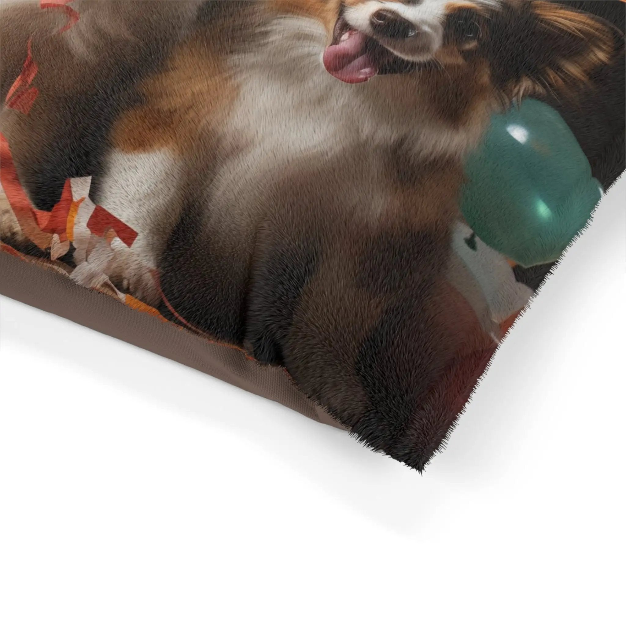 Pet Bed | a dog laying down with a balloon in its mouth