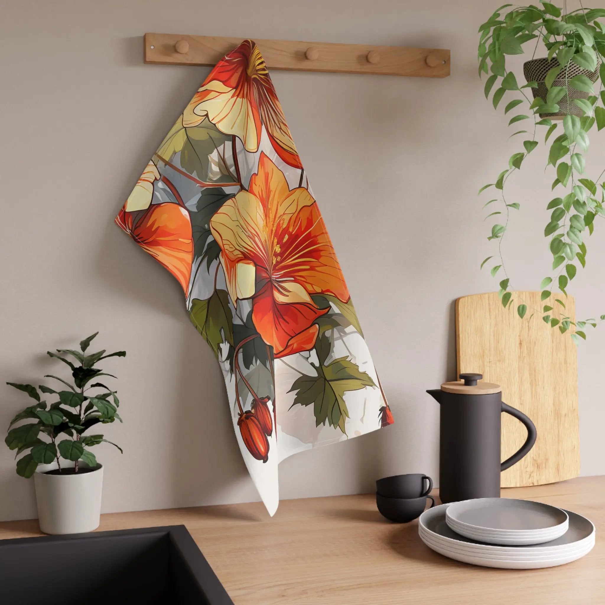 Kitchen Towel | a tea towel hanging on a wall next to a potted plant