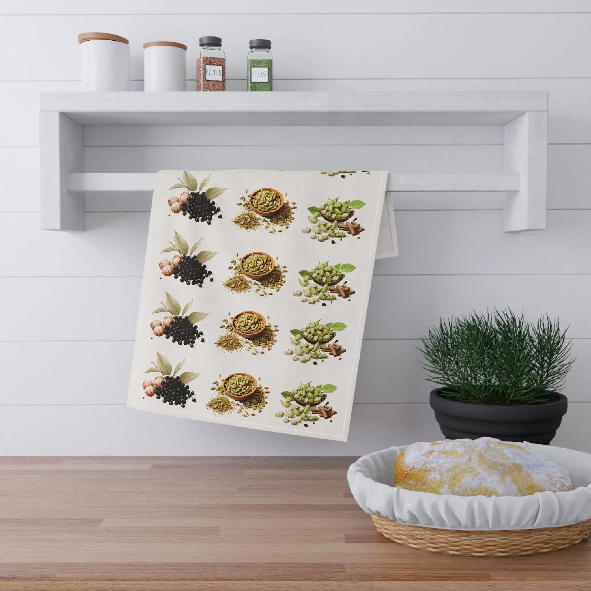 Kitchen Towel | a tea towel hanging on a wall next to a potted plant