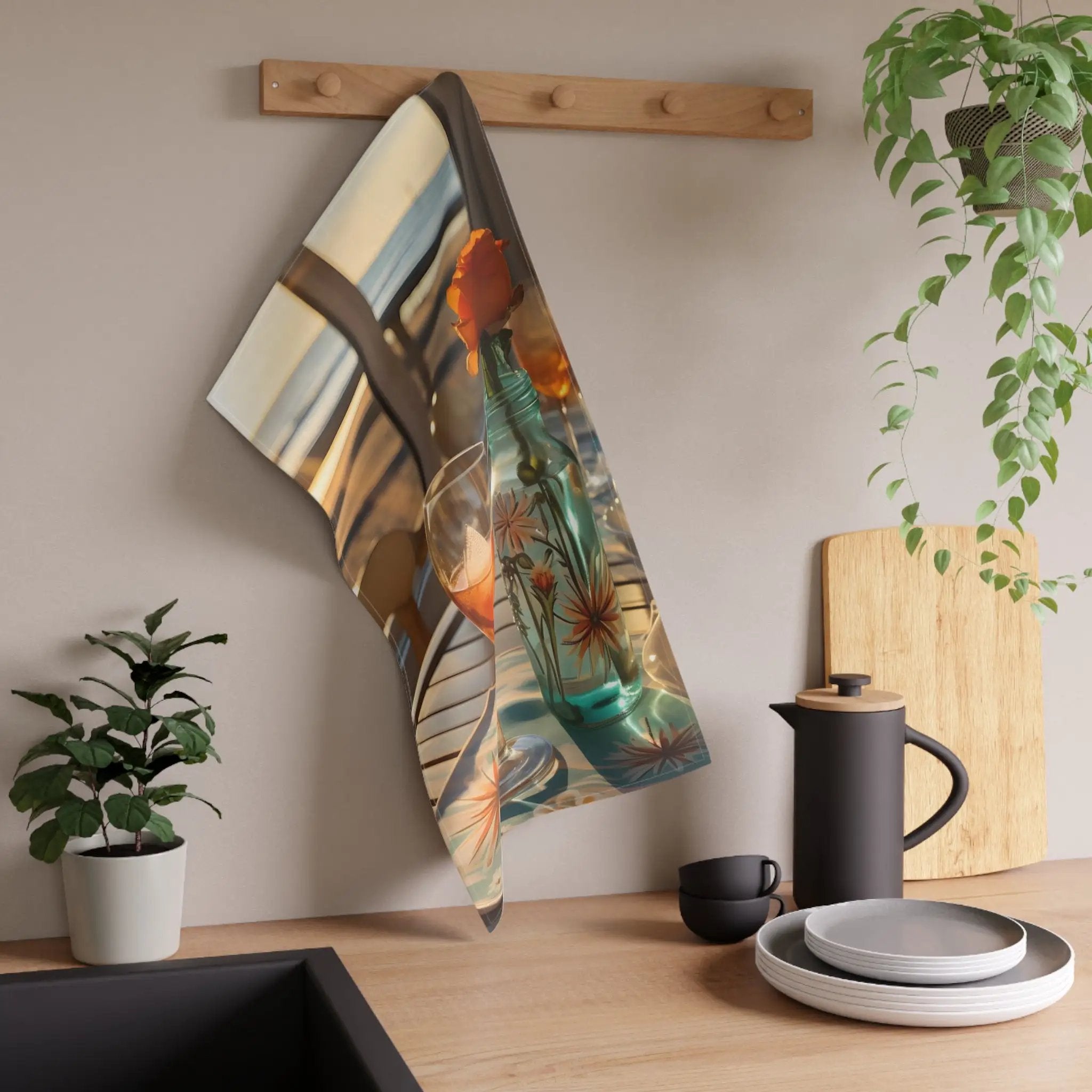 Kitchen Towel | a kitchen counter with a potted plant and a towel hanging on the wall