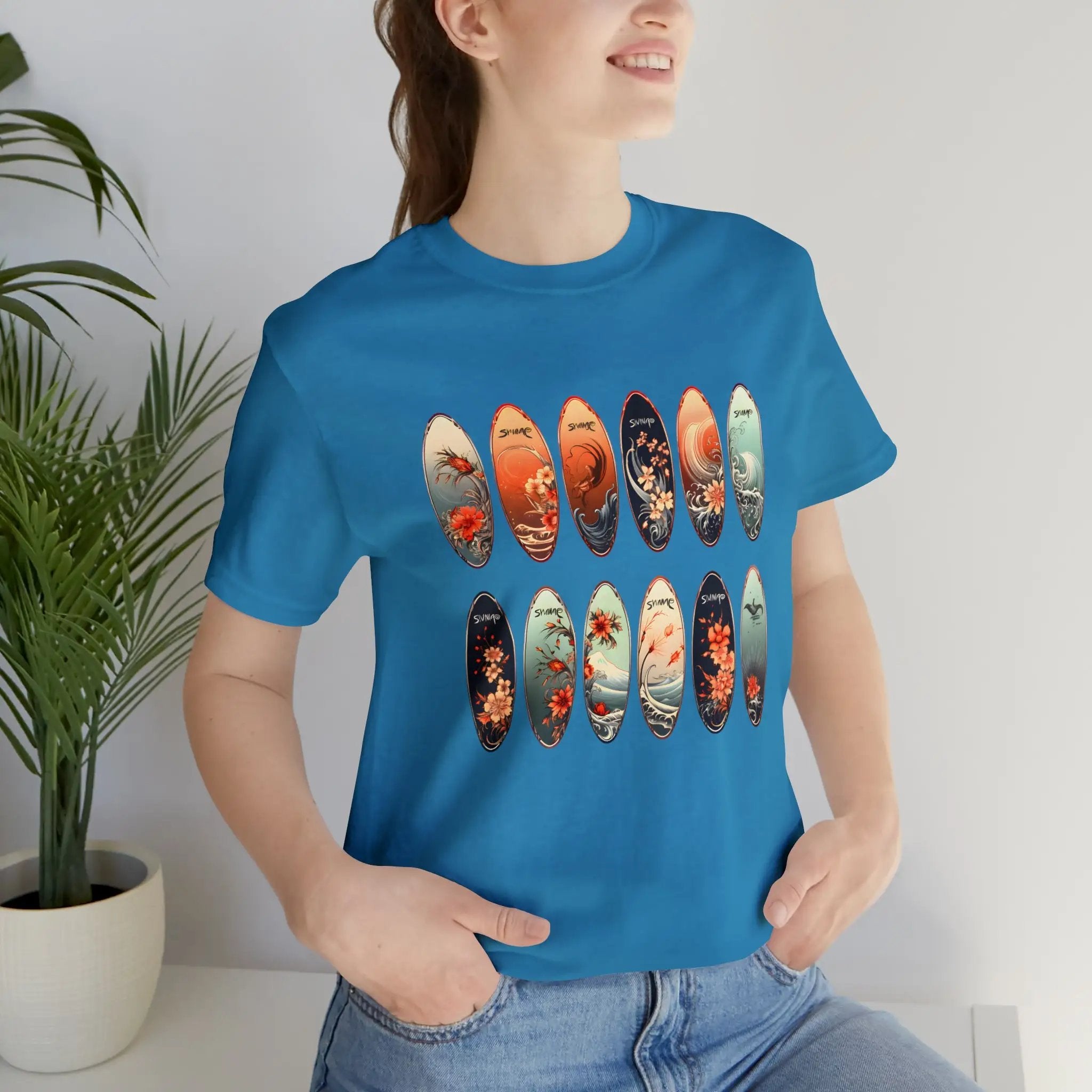 Couple t shirt | a woman wearing a blue t - shirt with a bunch of skateboards on it