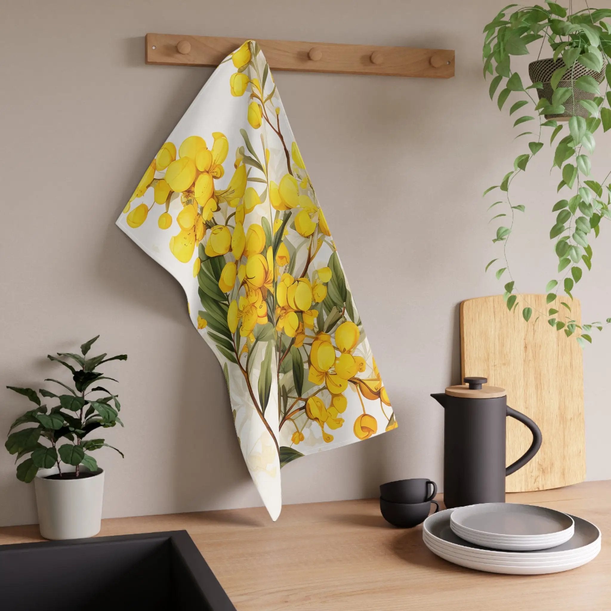 Kitchen Towel | a tea towel hanging on a wall next to a potted plant