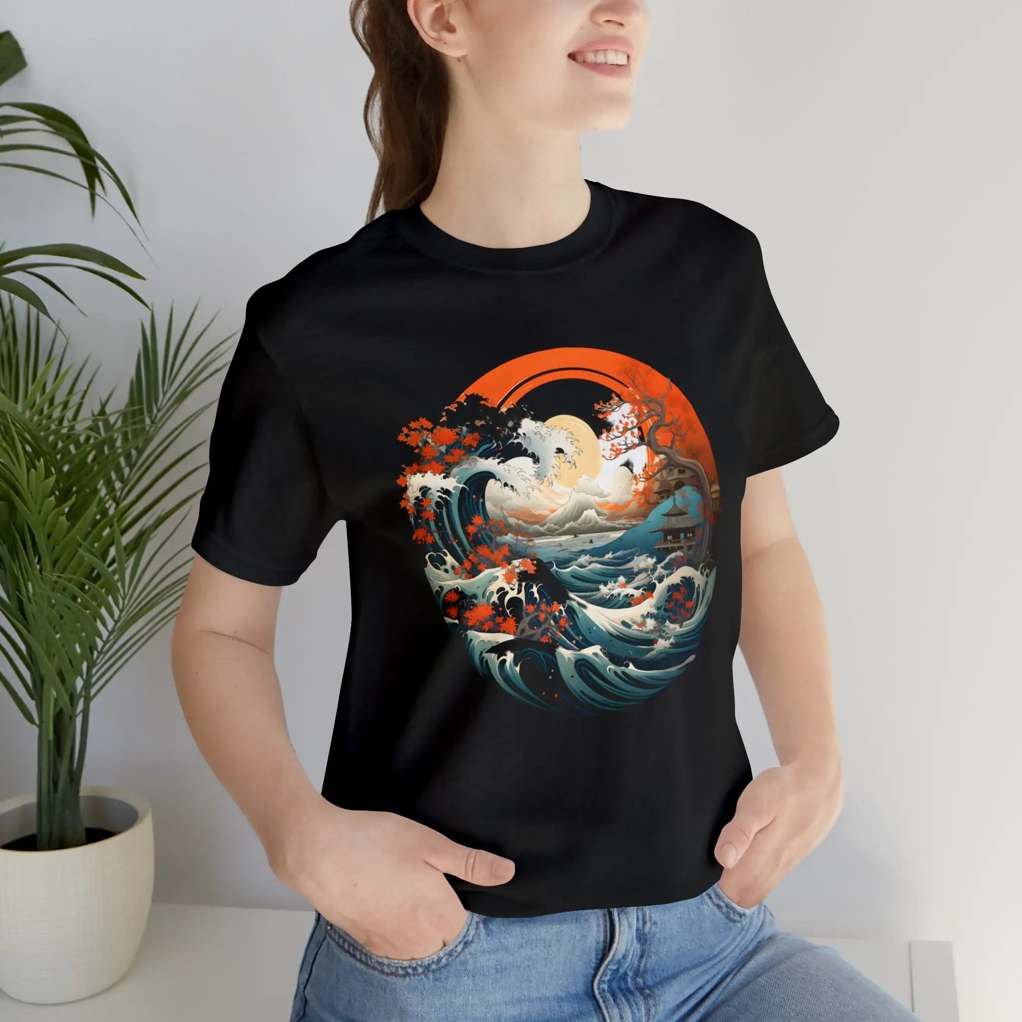 Couple t shirt | a woman wearing a black t - shirt with an image of a wave