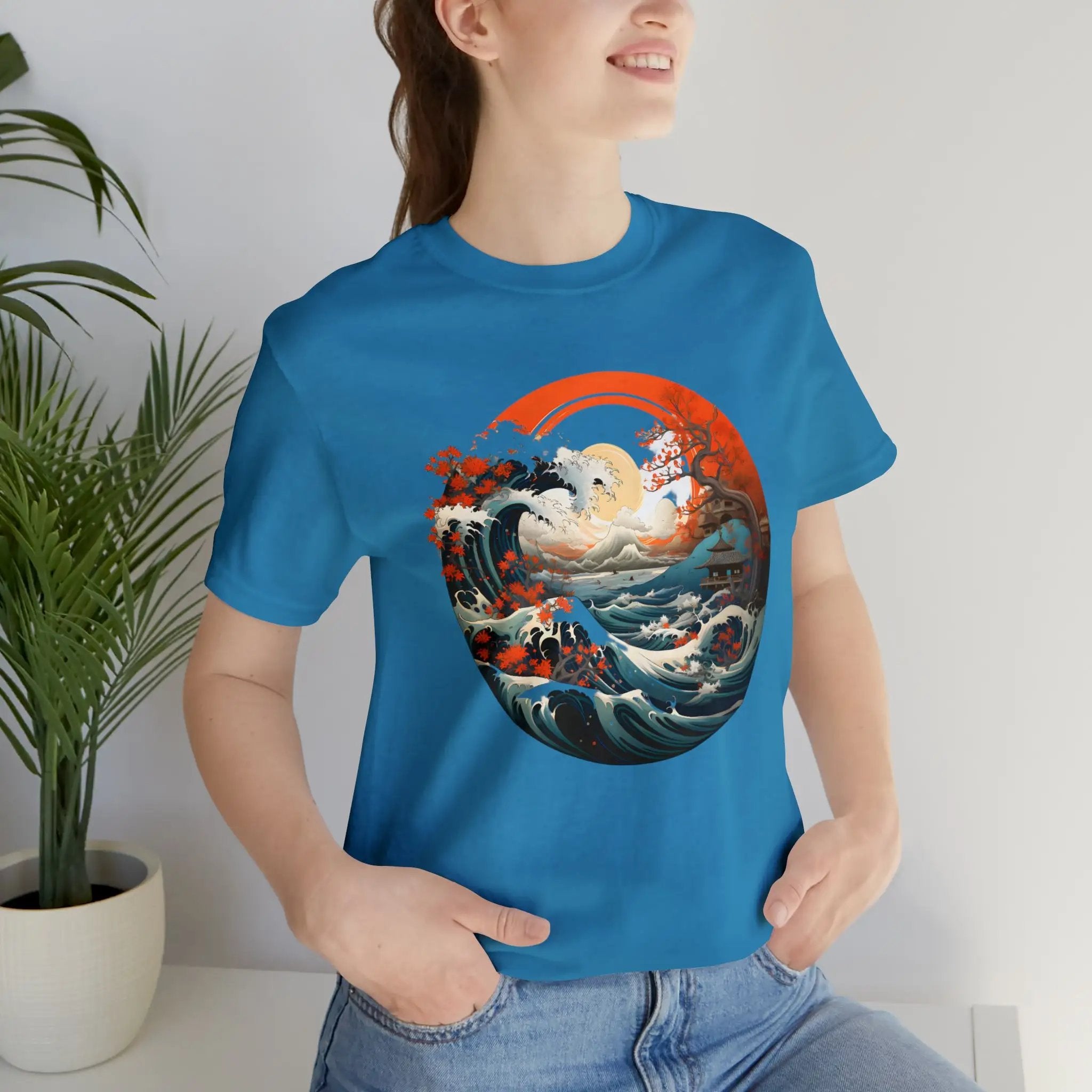 Couple t shirt | a woman wearing a blue t - shirt with an image of a wave