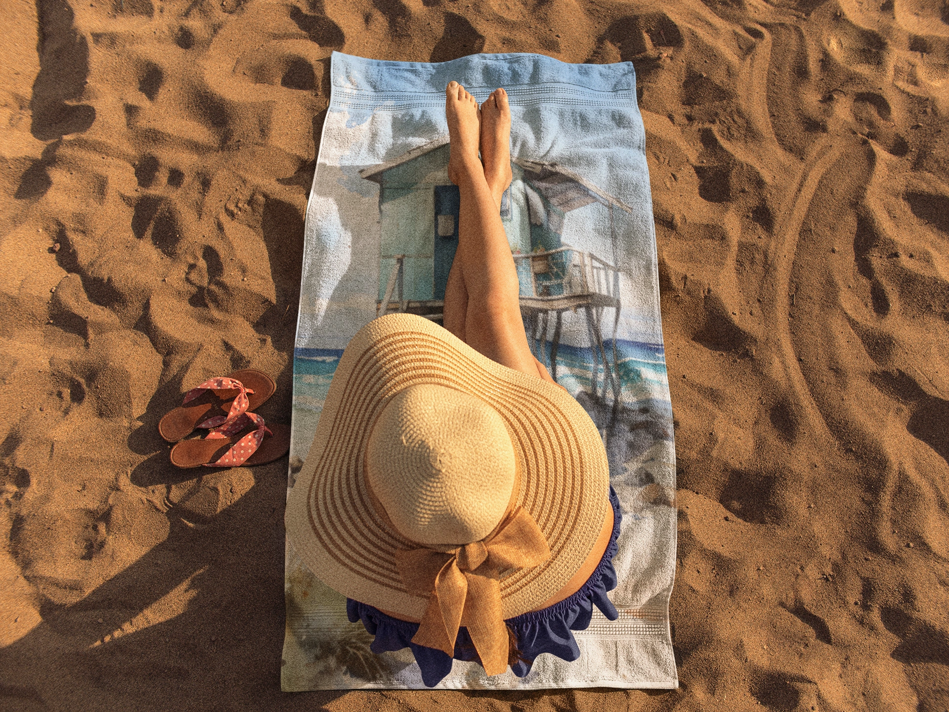 Best bath towel | a woman laying on top of a towel on top of a beach