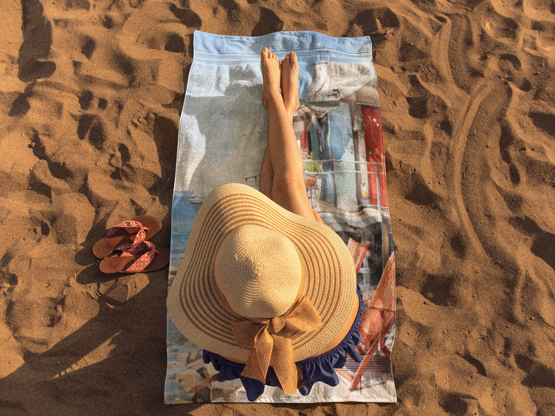 Best bath towel | a woman laying on top of a towel on top of a beach