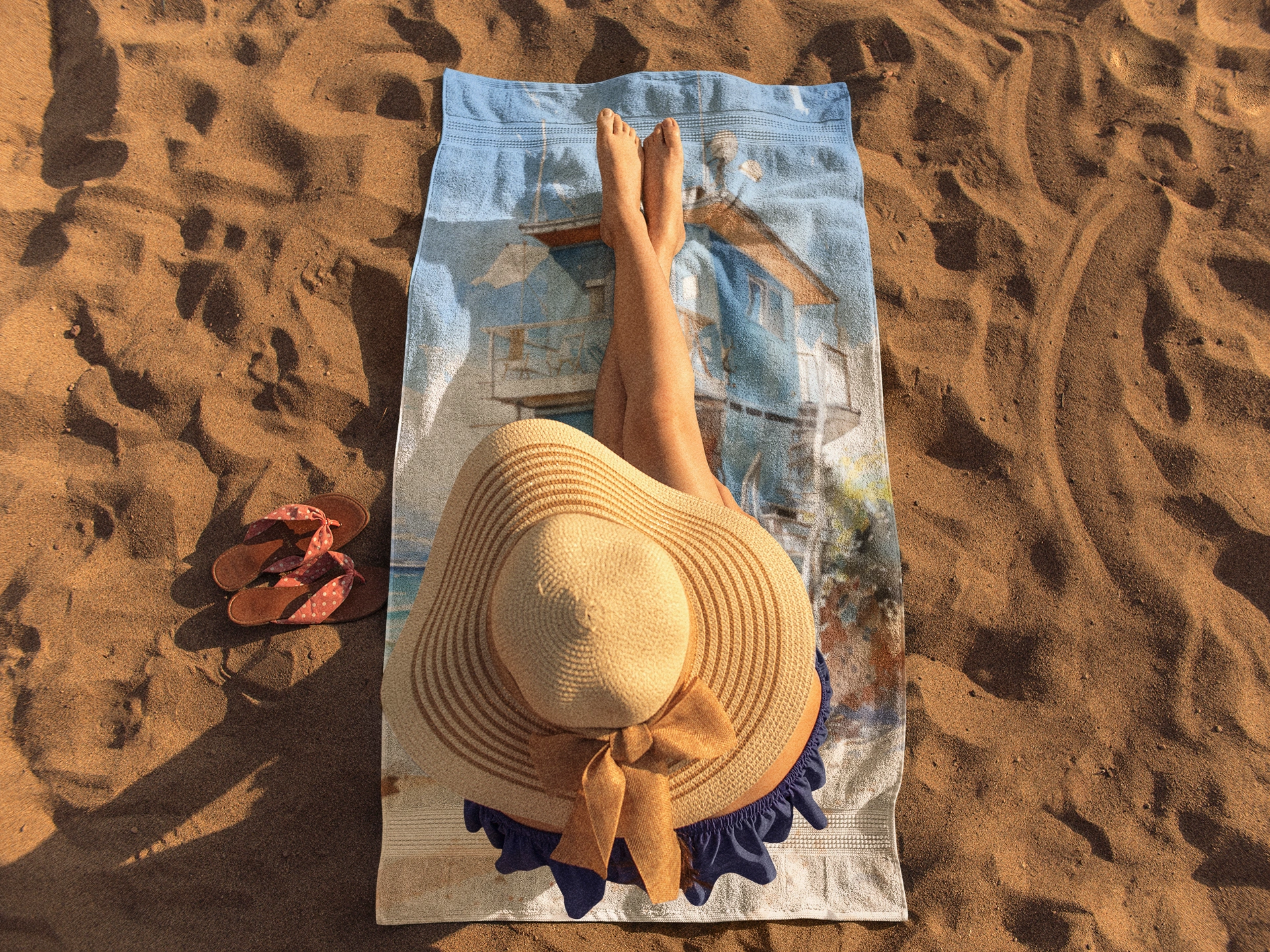 Best bath towel | a woman laying on top of a towel on top of a beach