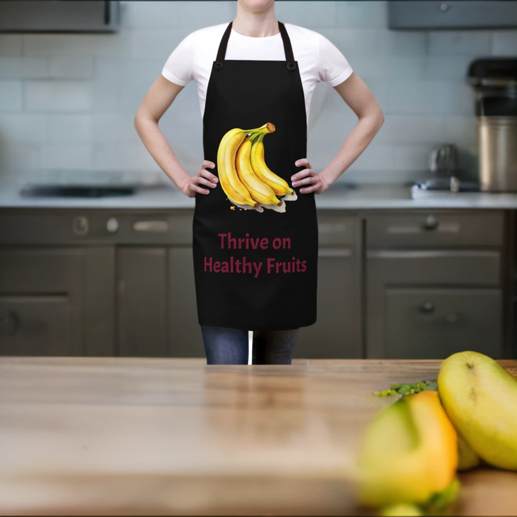 Chef Apron | a woman wearing a black apron with bananas on it